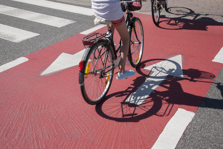 Cyclist on Bike Lane with Arrow Symbolの写真素材