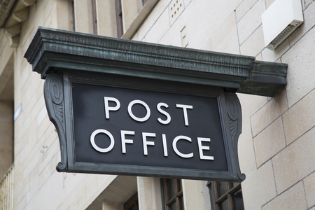 Post Office Sign on Building Facade