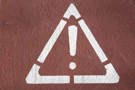 Exclamation Mark in Triangle Printed on Road Surfaceの写真素材