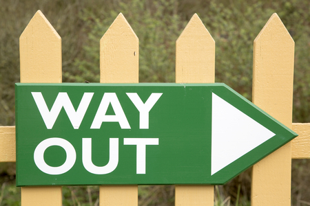 Old Way Out Sign on Wooden Fenceの写真素材