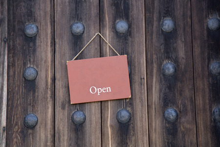 Red Open Sign on Wooden Doorの写真素材