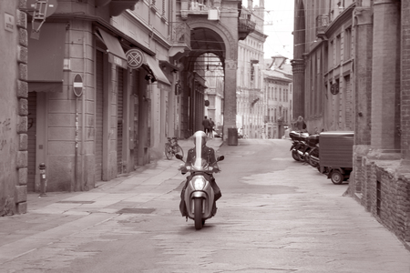 Motorcyclist riding through Bologna, Italy in Black and White, Sepia, Toneの写真素材