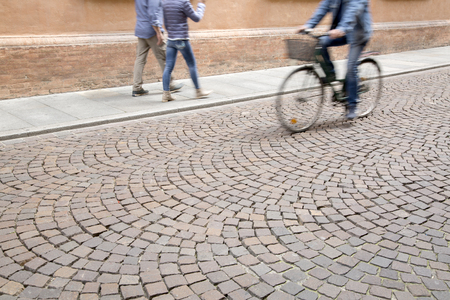 Cyclist on Cobblestone Streetの写真素材