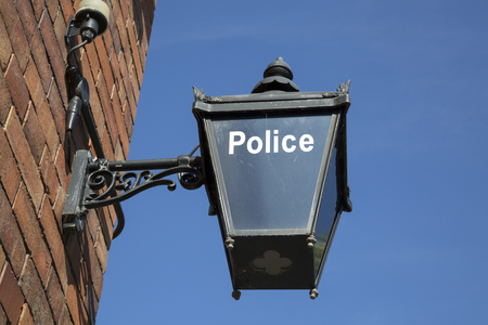 Blue Police Sign against Sky Backgroundの写真素材