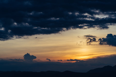 Beautiful sunset in the mountains. Beautiful sky with clouds at sunset. The scenery at sunset in...