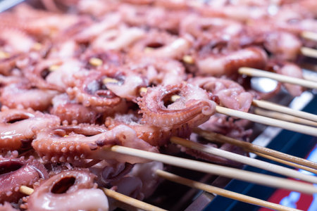 Grilled octopus on skewers in the market. Close upの写真素材