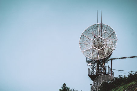 Satellite dish on the hill with blue sky background, vintage toneの写真素材