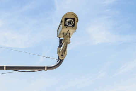 Grey security camera with blue sky backgroundの写真素材