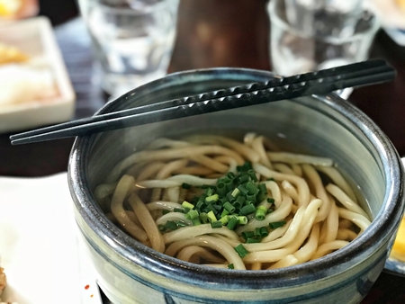 Japanese style hot Udon noodle with soup and side dish. A very delicious food in Japanの写真素材