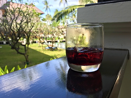 A cup of roselle drink and a green backgroundの写真素材