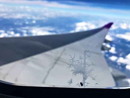 Ice forming crystal at the aircraft window at high altitudeの写真素材