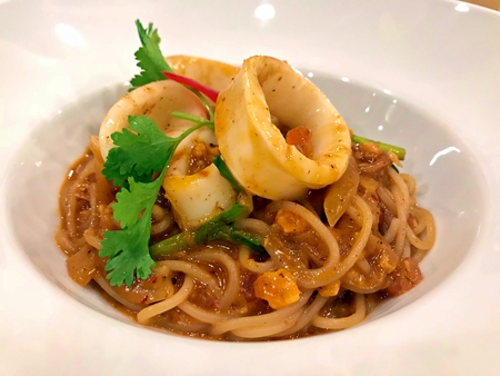 Fried spaghetti with thai style salted duck egg york with squidの写真素材
