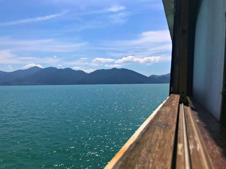 Sneak to the island from the ferry ship window, Koh Chang Ferry ship , Thailandの写真素材