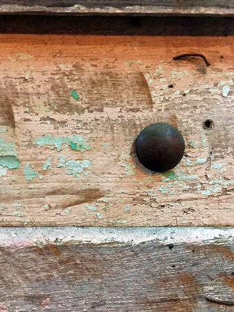 A vintage wooden wall with nail and peeling wood paint.の写真素材