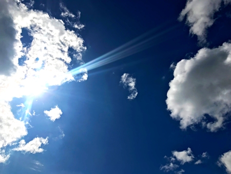Blue sky with cloud and beautiful sun flare in the noon time of Tachileik, Shan, Myanmarの写真素材