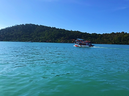 Tourist boat for snorkeling set sail on the green sea to their destination, Koh Chang, Thailandの写真素材