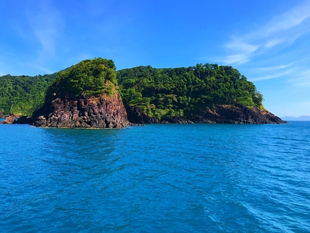 Sail through a beautiful green island with cloud and blue sea for snorkeling at Koh Chang, Thailandの写真素材