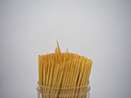 A box of tooth pick with white backgorund while one the toothpick is pike upの写真素材