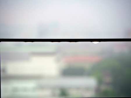 The heavy rain in the background cause the rain drop on the steel fence corridorの写真素材