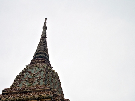 The pinnacle of the pagoda with cloudy sky in Wat Pho, Bangkok, Thailandの写真素材