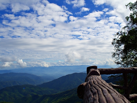 A wooden corridor with blue sky with cloud and mountainの写真素材