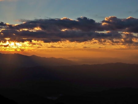 The landscape of the dawn and the warming light from the sun to the mountain and the mist and fogの写真素材