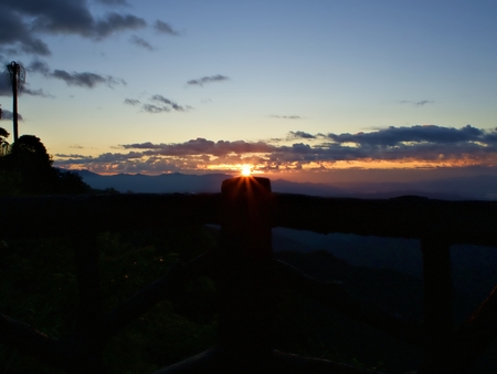 The sun that shine and flare above wooden corridor with forest and sky with cloud landscapeの写真素材