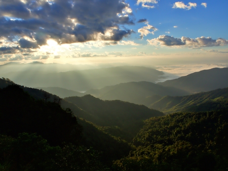 A ray of light over the green mountain in Nan, Thailandの写真素材