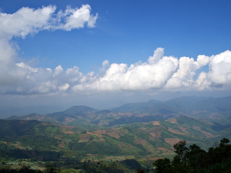 The landscape of green mountain and the pattern of cloud and blueskyの写真素材