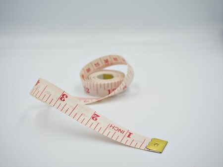 Isolated shot on the measuring tape with white background and mainly focus at the edge of tape