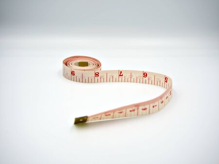 Upside down shot on the measuring tape with white background and showing both cm and inches scaleの写真素材