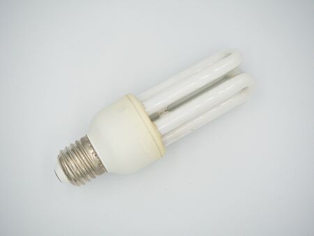 Top shot on the used energy saving bulb with showing both screw base and bulb with isolated white backgroundの写真素材