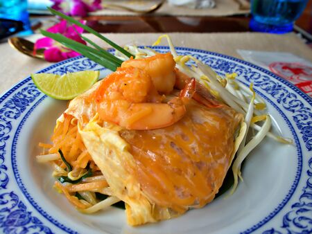 Focus shot on the prawn pad-thai with lemon on the plateの写真素材