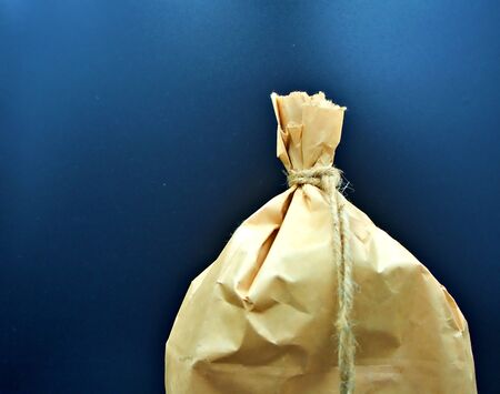 Focus shot on the brown paper bag with tie in the black backgroundの写真素材