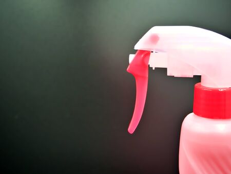 Pink spray bottle in the black backgroundの写真素材