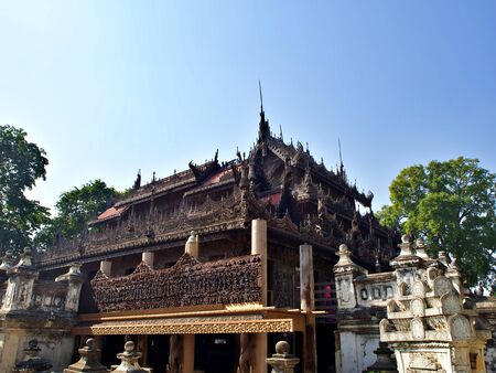 The famous Shwenandaw monastery with outside compound and blue sky in Mandalay, Myanmarのeditorial素材