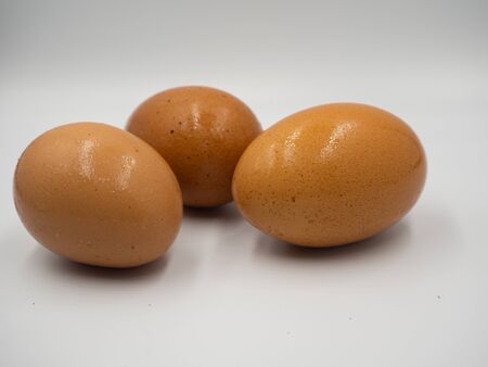 Close up shot on the three eggs that placed on the white backgroundの写真素材