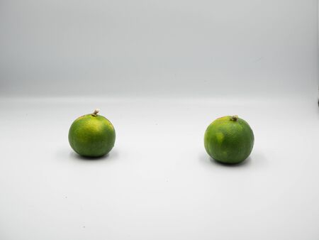 Two limes placed in the isolated white backgroundの写真素材