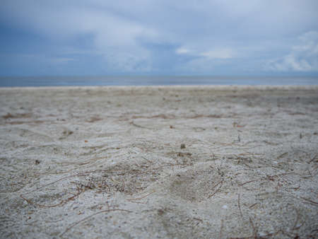 The cloudy sky and the reflection of it in the sea beach at Kuiburi, Thailandの写真素材