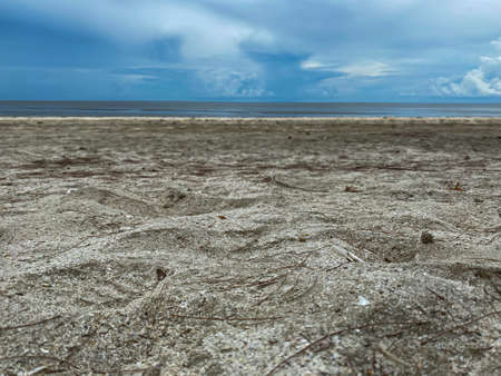 The sand beach and the rain cloud sky with the sea Thailandの写真素材
