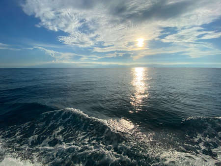 The wave from of the boat to the sea and the sun at horizon at Koh Tao, Thailandの写真素材