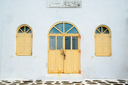 Old door and windows on the white buildingの写真素材