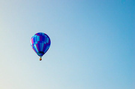 A hot air balloon floating in the blue sky