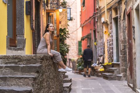 Woman sitting on wall stairs