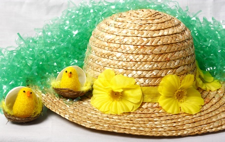 An image showing the concept of Easter with a bonnet and some chicksの写真素材