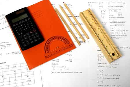 An image showing a book and a pencil case with some pencils