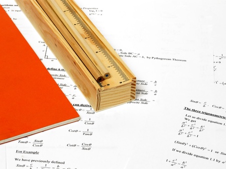 An image showing a book and a pencil case with some pencils