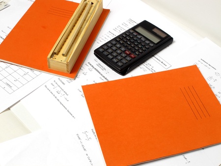 An image showing a calculator, a book and a pencil case with some pencilsの写真素材