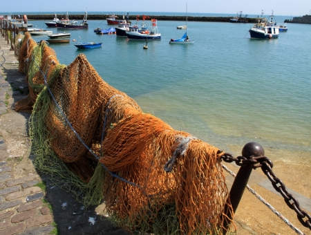 An image showing the fishing nets by the harbour sideの写真素材