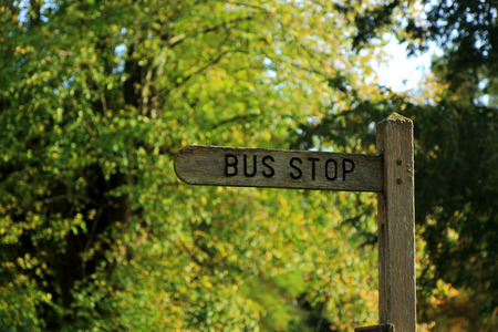 A wooden sign for a bus stopの写真素材